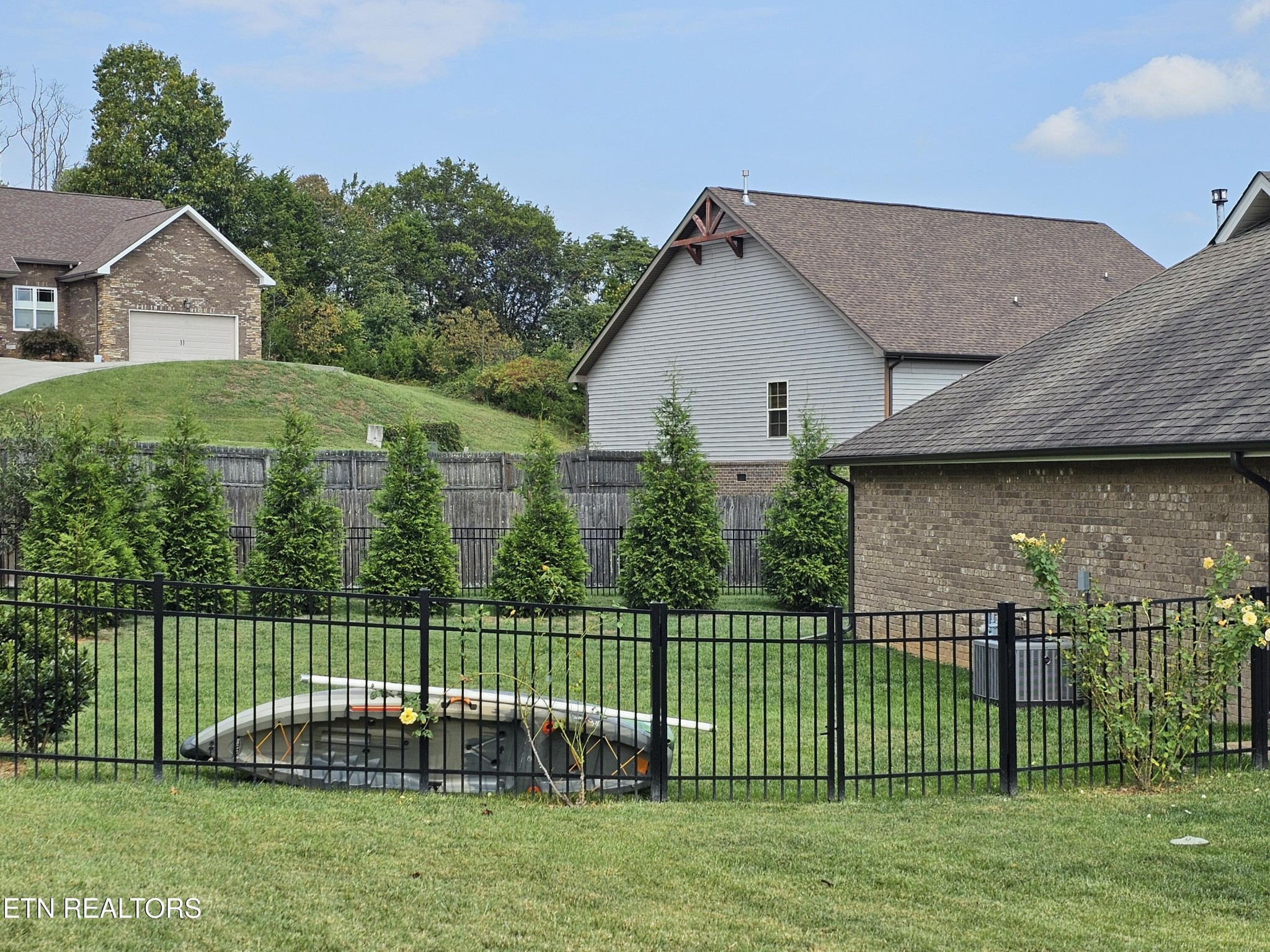 5920 Whisper Ridge Lane Corryton, TN 37721 - Photo 37 of 49 a view of a house with a backyard and a garden