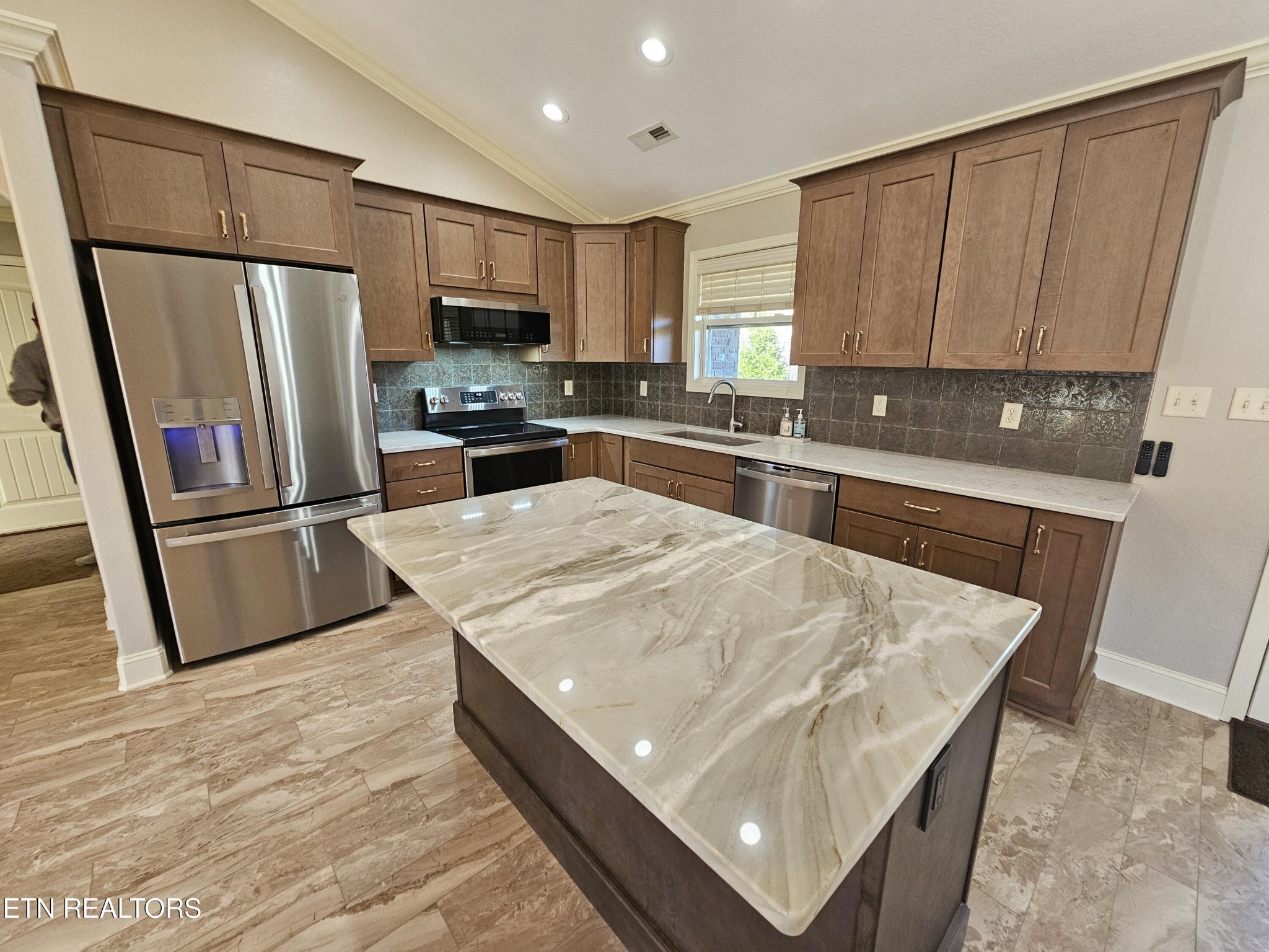 5920 Whisper Ridge Lane Corryton, TN 37721 - Photo 4 of 49 a kitchen with stainless steel appliances granite countertop a refrigerator oven a sink dishwasher and wooden cabinets with wooden floor