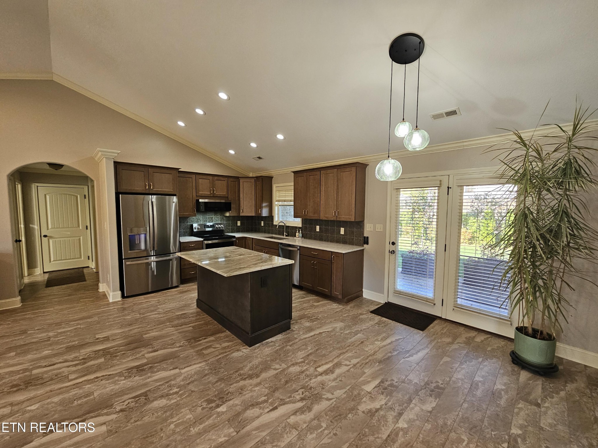 5920 Whisper Ridge Lane Corryton, TN 37721 - Photo 5 of 49 a kitchen with stainless steel appliances kitchen island granite countertop a refrigerator and a sink