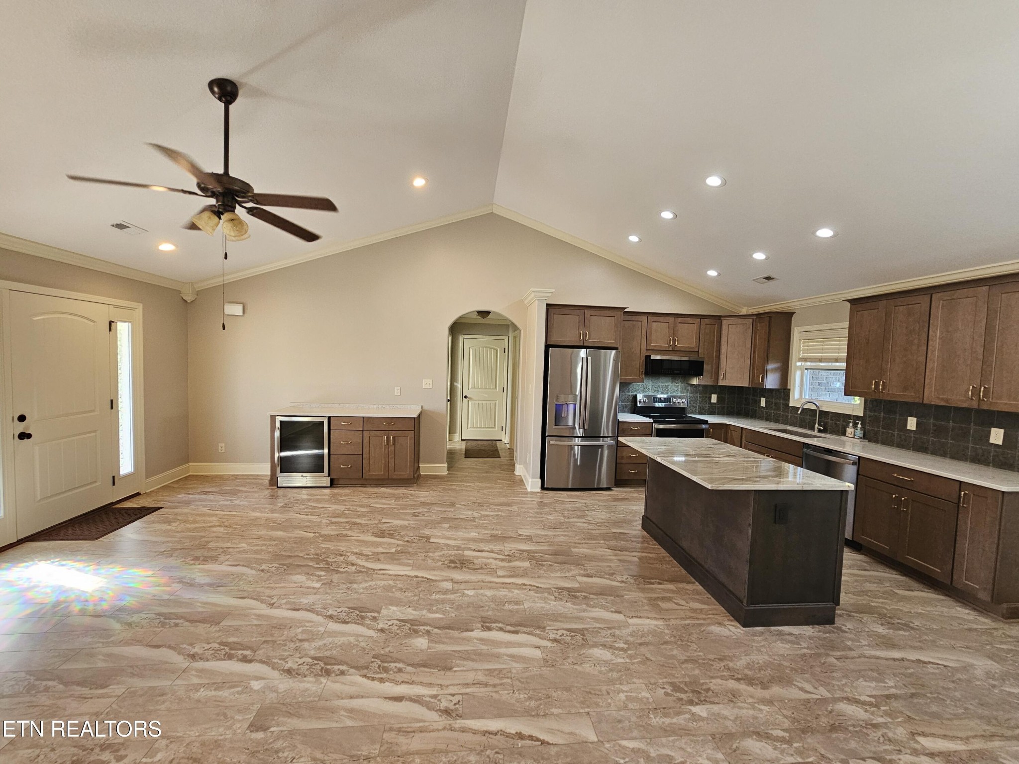 5920 Whisper Ridge Lane Corryton, TN 37721 - Photo 7 of 49 a large kitchen with stainless steel appliances kitchen island a large counter top a stove and a refrigerator