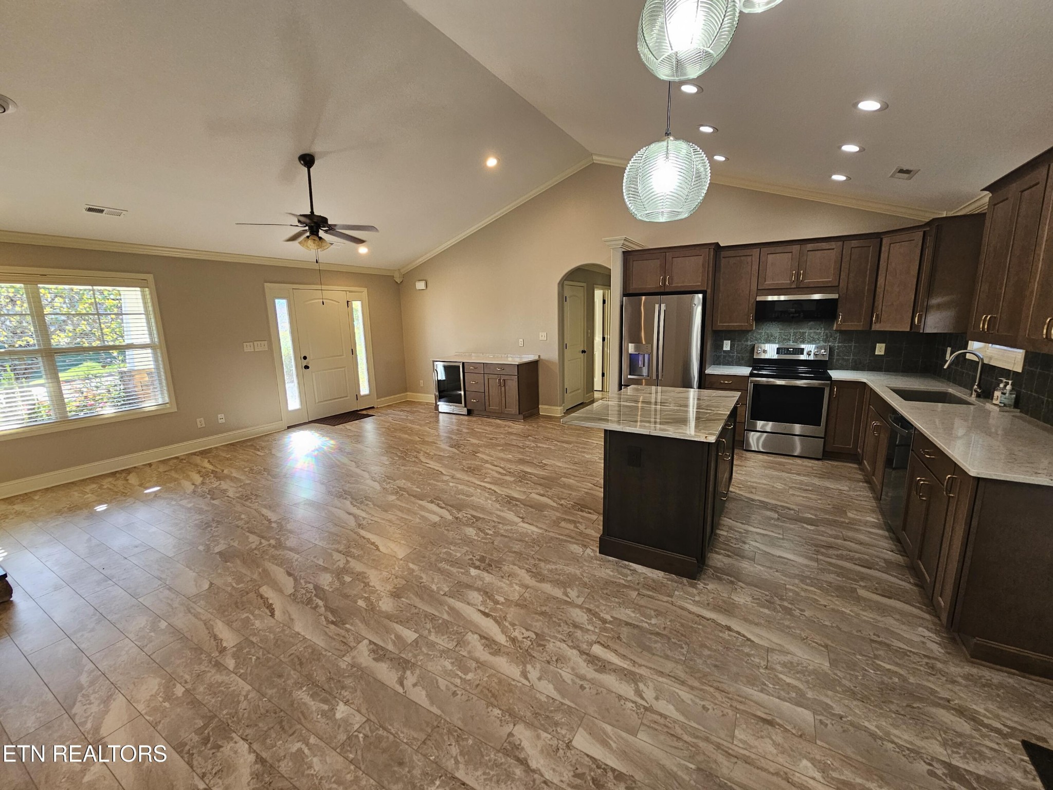 5920 Whisper Ridge Lane Corryton, TN 37721 - Photo 9 of 49 a large kitchen with stainless steel appliances a large counter top and a stove