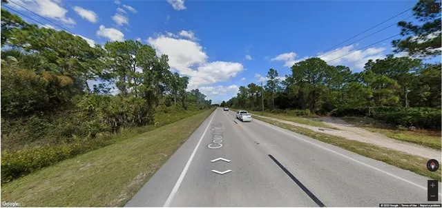 a view of a street with a yard