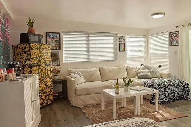 a living room with furniture a dining table and a window