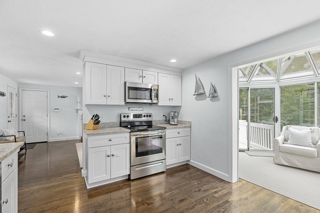 37 Old Forge Road Scituate, MA 02066 - Photo 13 of 42 a kitchen with stainless steel appliances white cabinets a sink a stove a refrigerator and a microwave