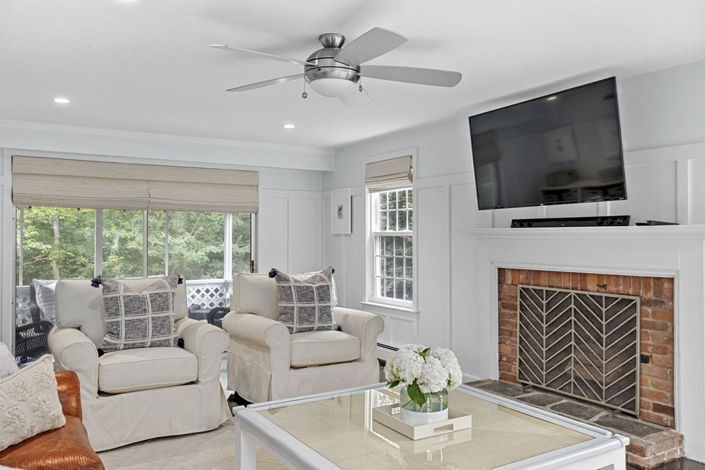 37 Old Forge Road Scituate, MA 02066 - Photo 20 of 42 a living room with furniture a flat screen tv and a fireplace