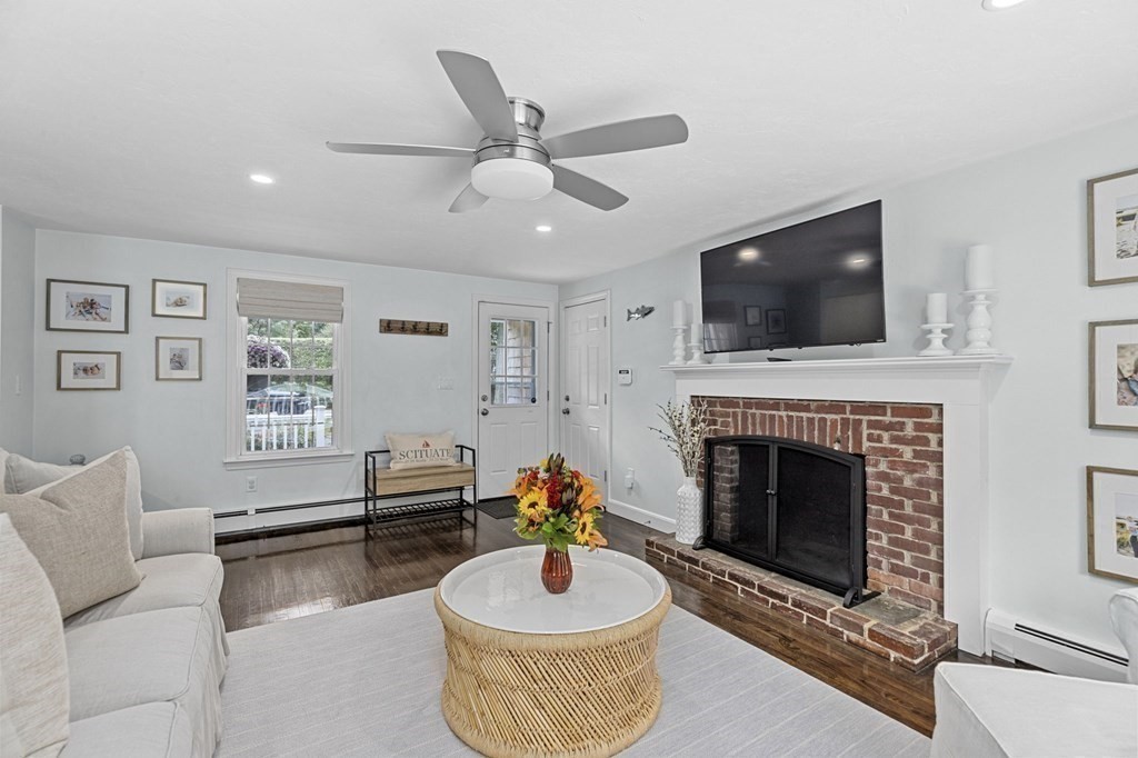 37 Old Forge Road Scituate, MA 02066 - Photo 7 of 42 a living room with furniture a flat screen tv and a fireplace