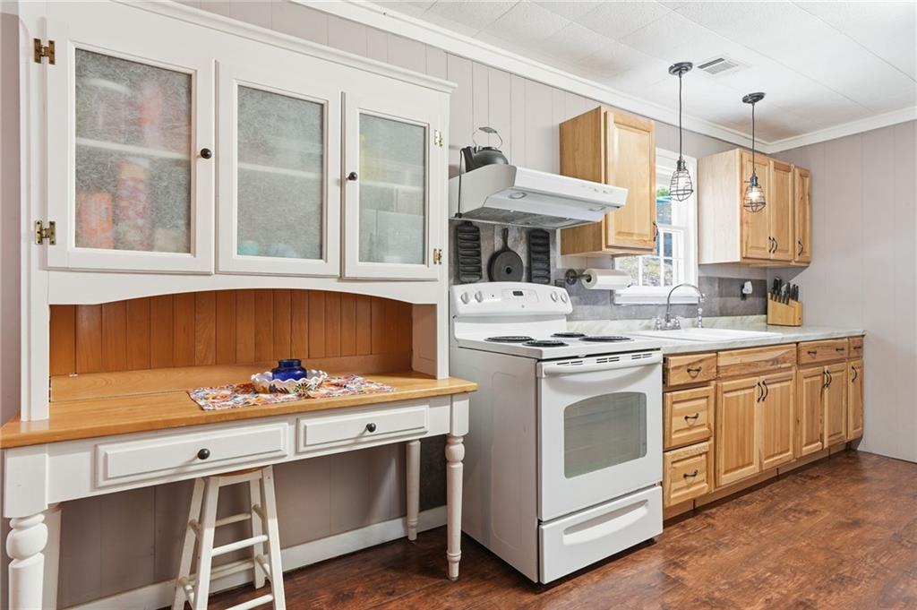 1709 Harrington Road Ball Ground, GA 30107 - Photo 12 of 46 a kitchen with stainless steel appliances a stove sink and cabinets