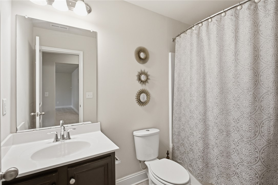 120 Jones Creek Circle Anderson, SC 29621 - Photo 32 of 43 This bright bathroom features a vanity with a white countertop, offering a clean and functional space.