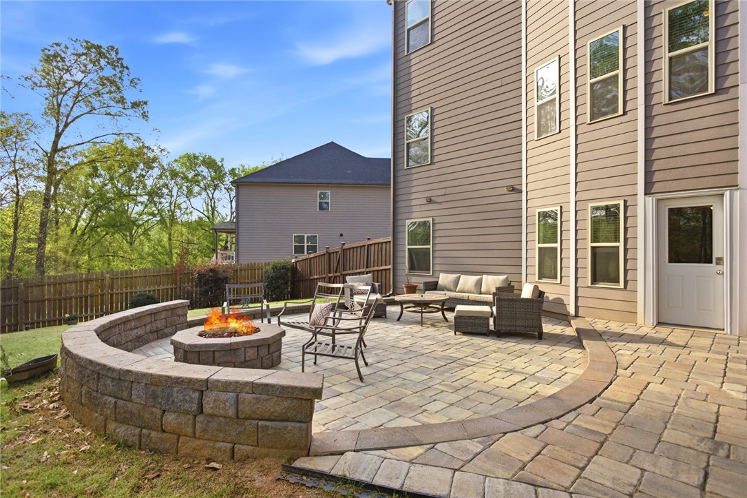 120 Jones Creek Circle Anderson, SC 29621 - Photo 39 of 43 Enjoy outdoor living with this expansive patio featuring a built-in fire pit, perfect for entertaining.