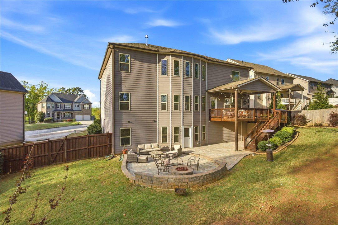 120 Jones Creek Circle Anderson, SC 29621 - Photo 42 of 43 This home features an expansive deck with stairs to a lush yard and patio with a fire pit.