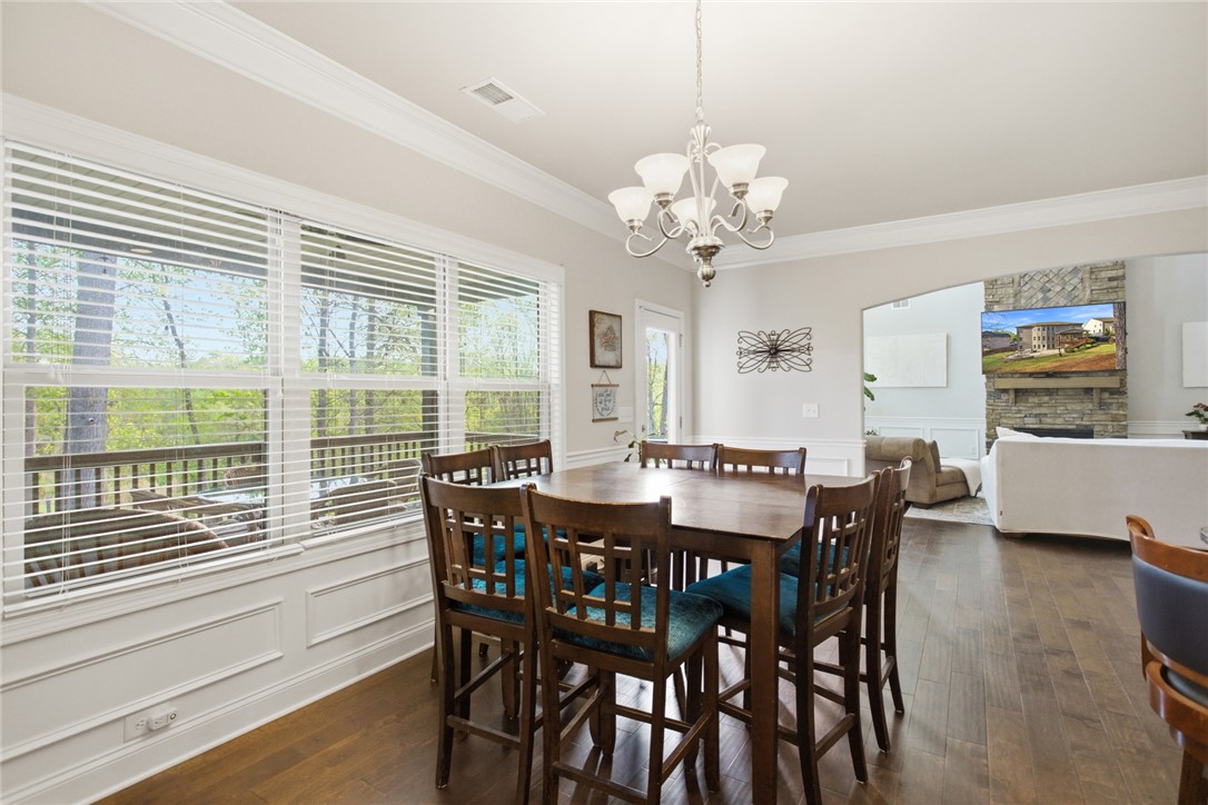 120 Jones Creek Circle Anderson, SC 29621 - Photo 9 of 43 Bright dining area with hardwood floors, crown molding, and outdoor access.