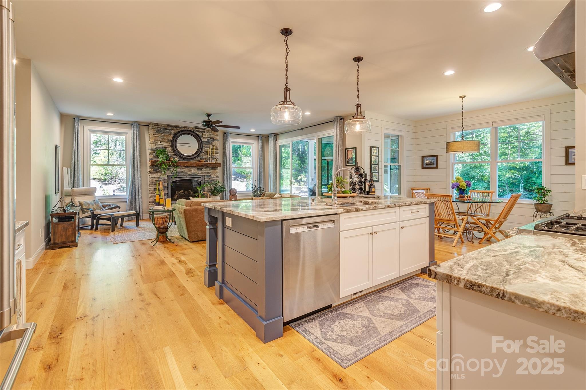 21 Ducketts Grove Road Fletcher, NC 28732 - Photo 12 of 42 a large white kitchen with a large window a sink dishwasher and a stove with wooden floor