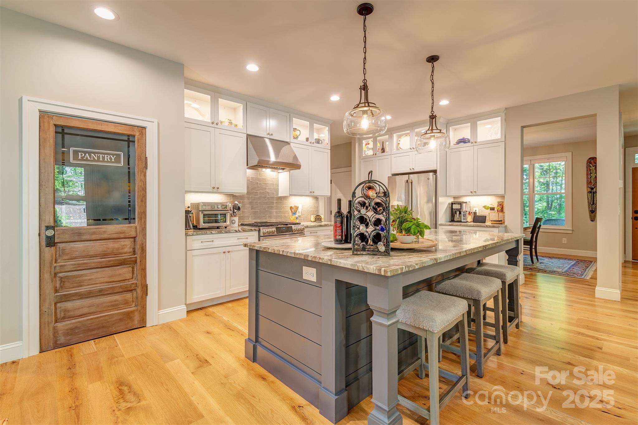 21 Ducketts Grove Road Fletcher, NC 28732 - Photo 14 of 42 a kitchen with kitchen island a stove a table and chairs in it
