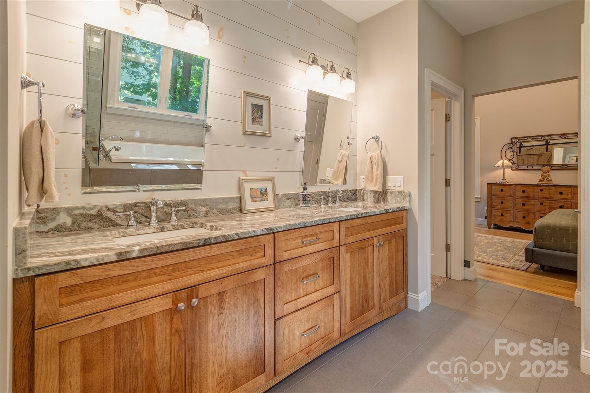 21 Ducketts Grove Road Fletcher, NC 28732 - Photo 24 of 42 a en suite bathroom with a granite countertop sink and a large mirror