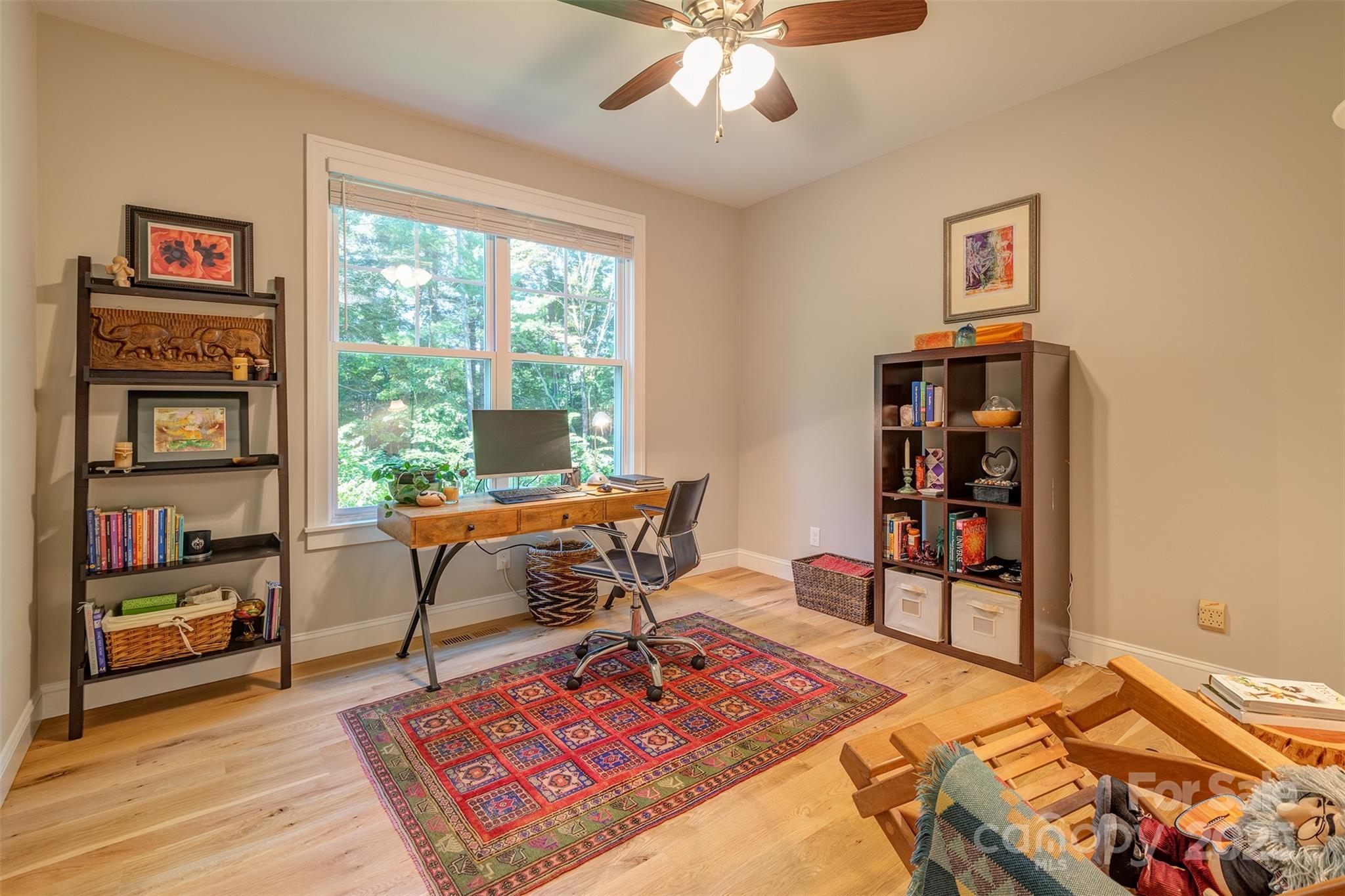 21 Ducketts Grove Road Fletcher, NC 28732 - Photo 25 of 42 a living room with furniture a rug and a bookshelf