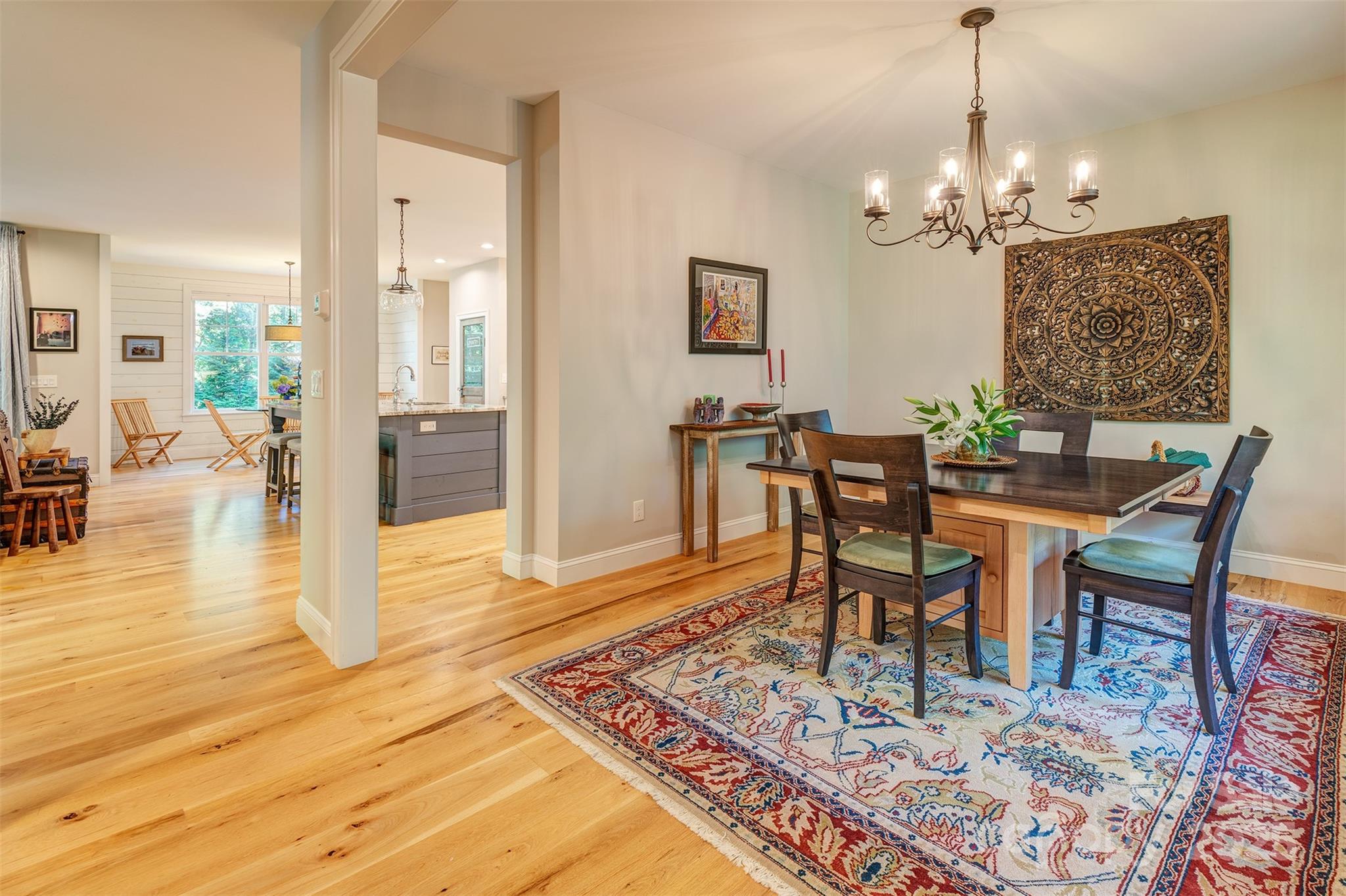 21 Ducketts Grove Road Fletcher, NC 28732 - Photo 6 of 42 a dining room with wooden floor a chandelier a wooden table and chairs