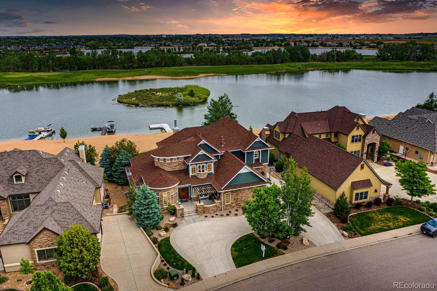 1820 Seashell Court Windsor, CO 80550 - Photo 1 of 40 an aerial view of a house with outdoor space and lake view