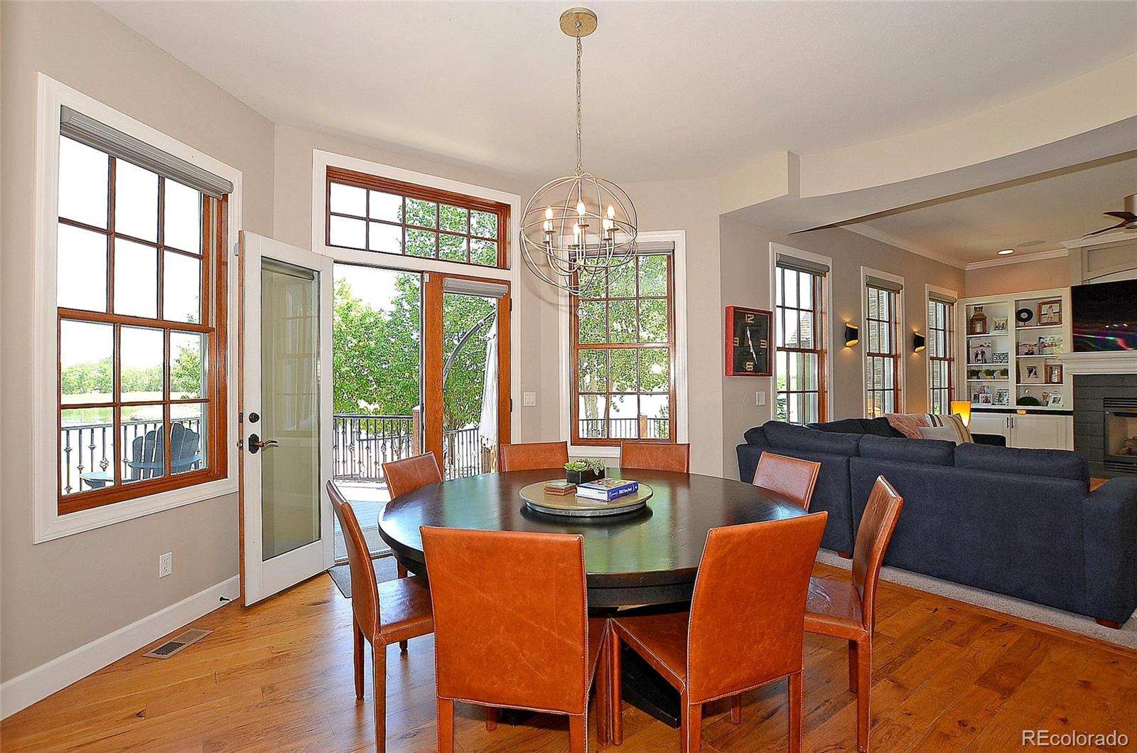 1820 Seashell Court Windsor, CO 80550 - Photo 11 of 40 a dining room with furniture a chandelier and wooden floor