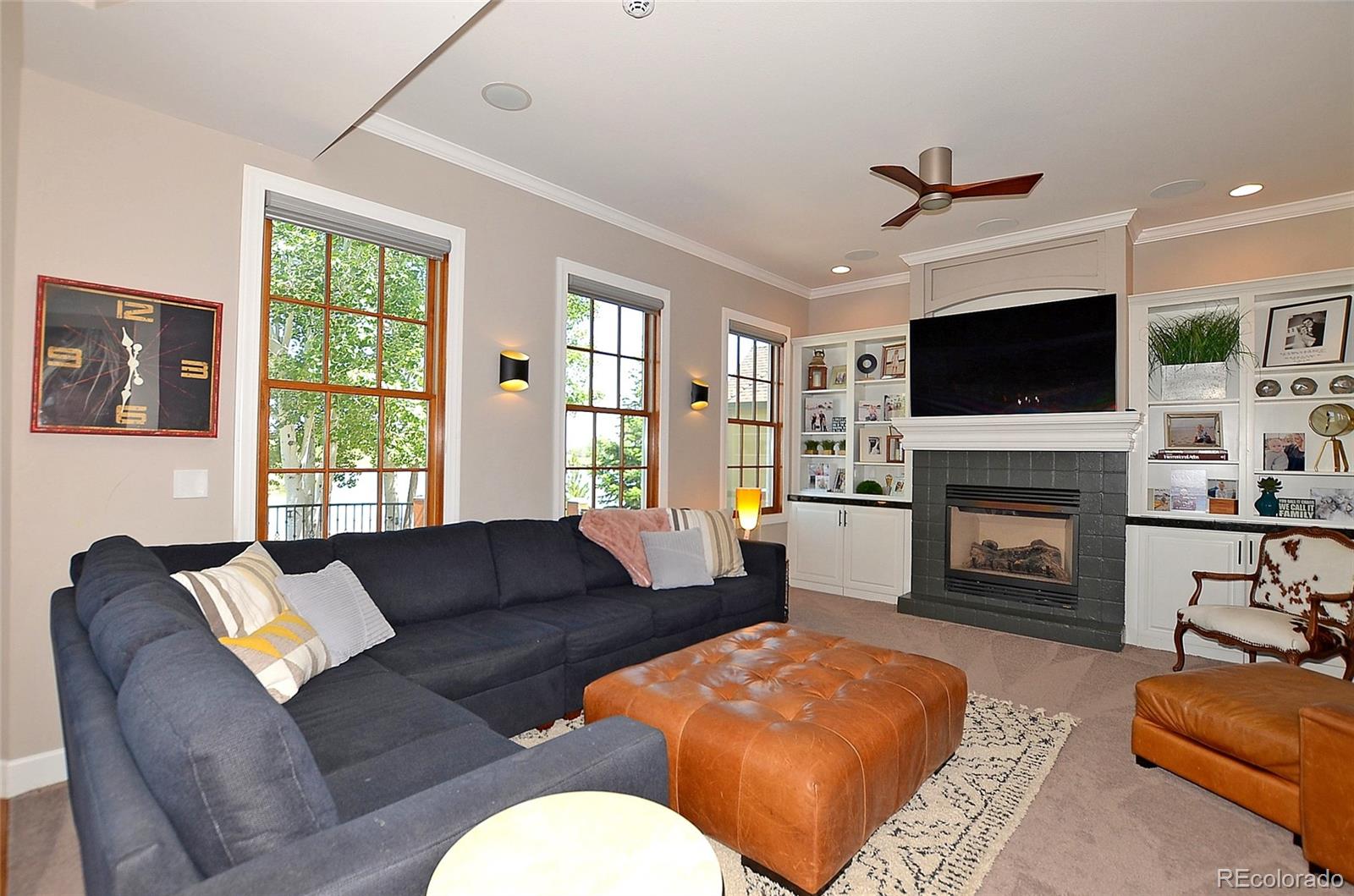 1820 Seashell Court Windsor, CO 80550 - Photo 12 of 40 a living room with furniture a fireplace and a flat screen tv