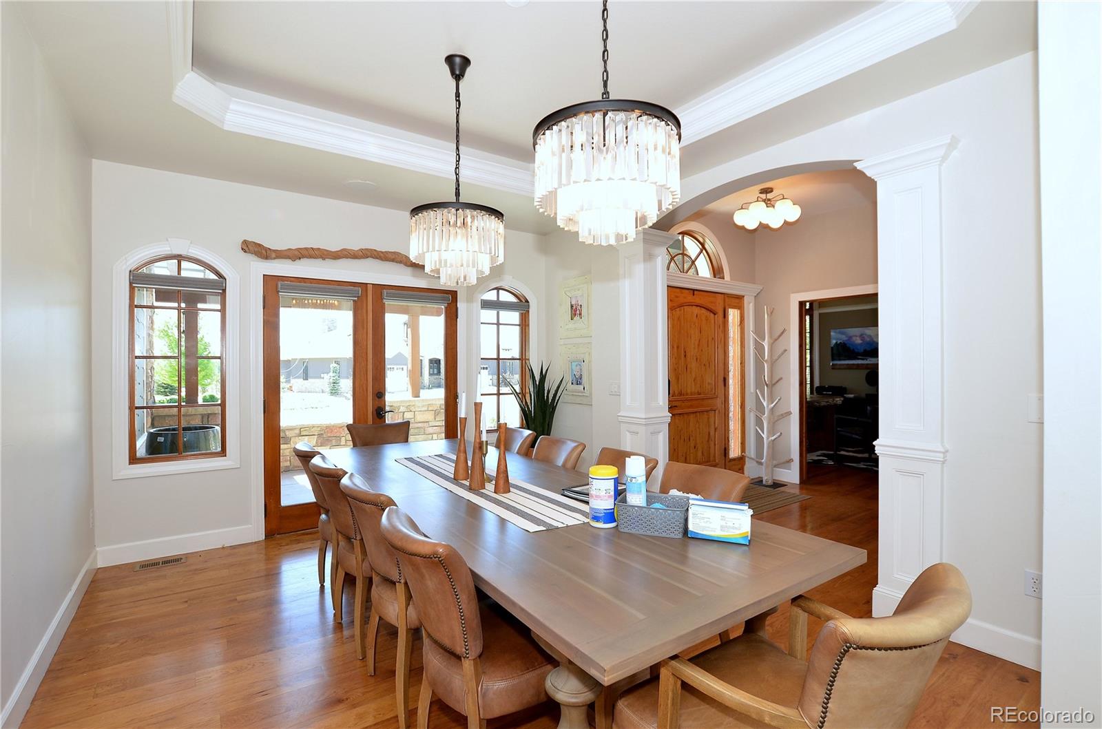 1820 Seashell Court Windsor, CO 80550 - Photo 15 of 40 a view of a dining room with furniture wooden floor and chandelier
