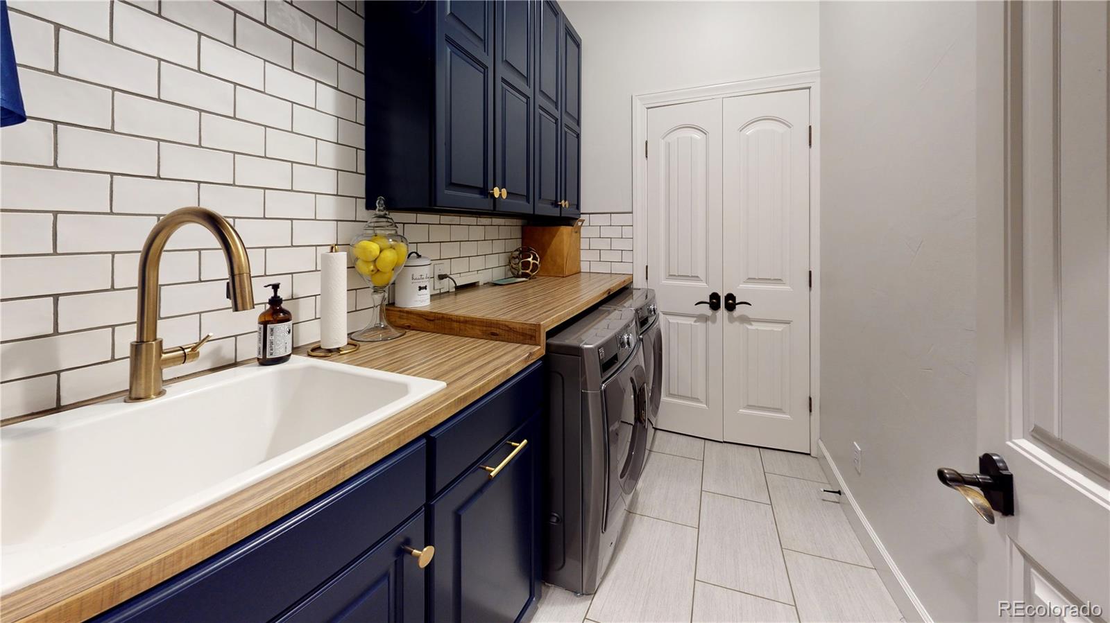 1820 Seashell Court Windsor, CO 80550 - Photo 17 of 40 a kitchen with a sink a stove cabinets and a window