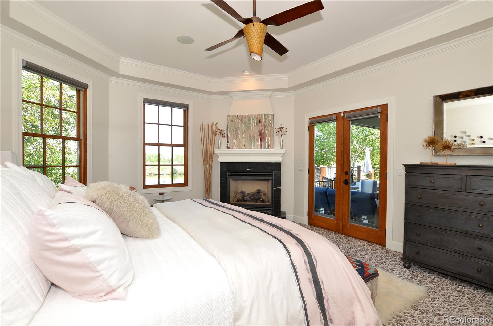 1820 Seashell Court Windsor, CO 80550 - Photo 19 of 40 a bedroom with a large bed and a tv