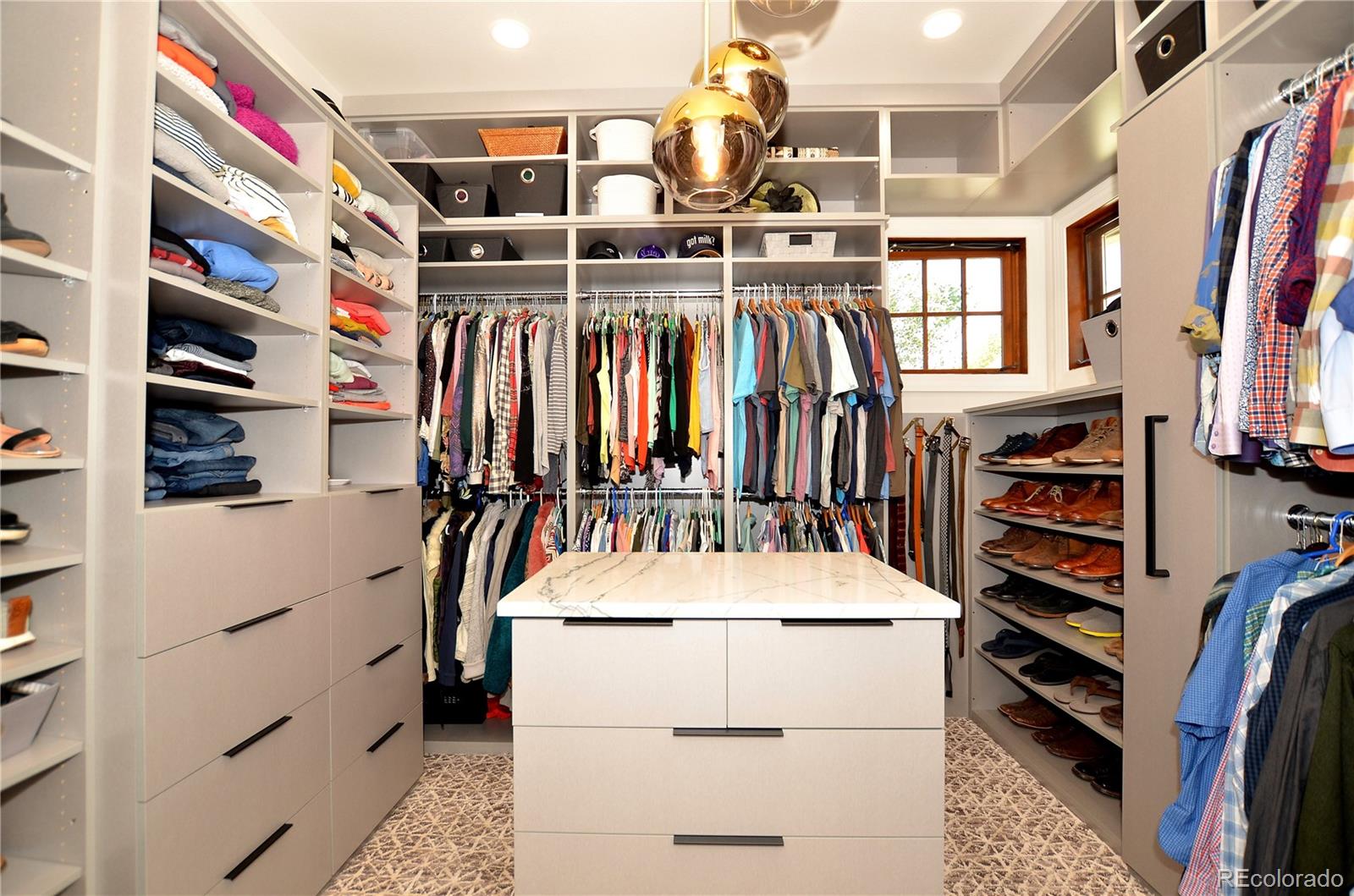 1820 Seashell Court Windsor, CO 80550 - Photo 22 of 40 a view of walk in closet with clothes and shoes