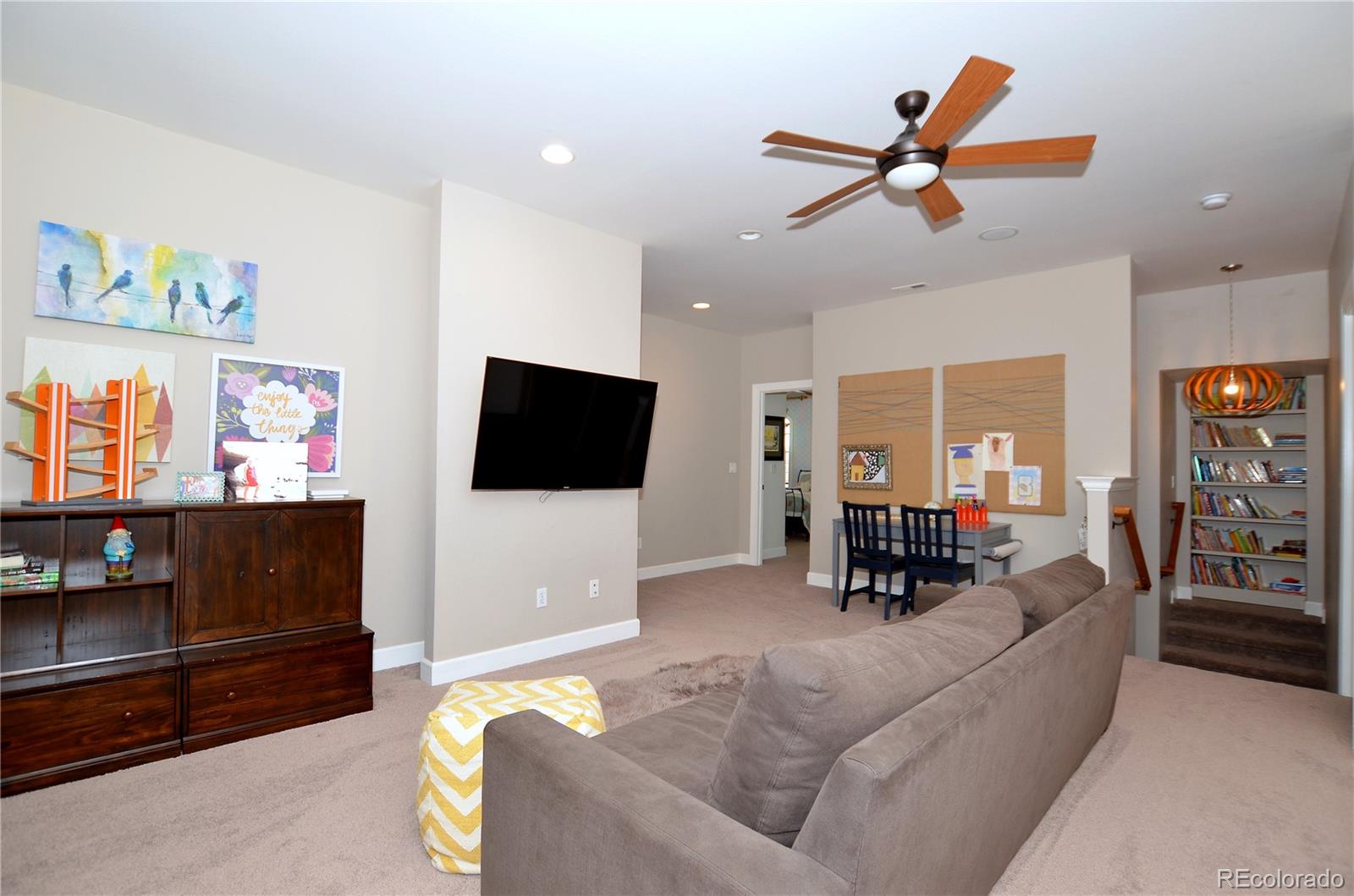 1820 Seashell Court Windsor, CO 80550 - Photo 23 of 40 a living room with furniture and a flat screen tv