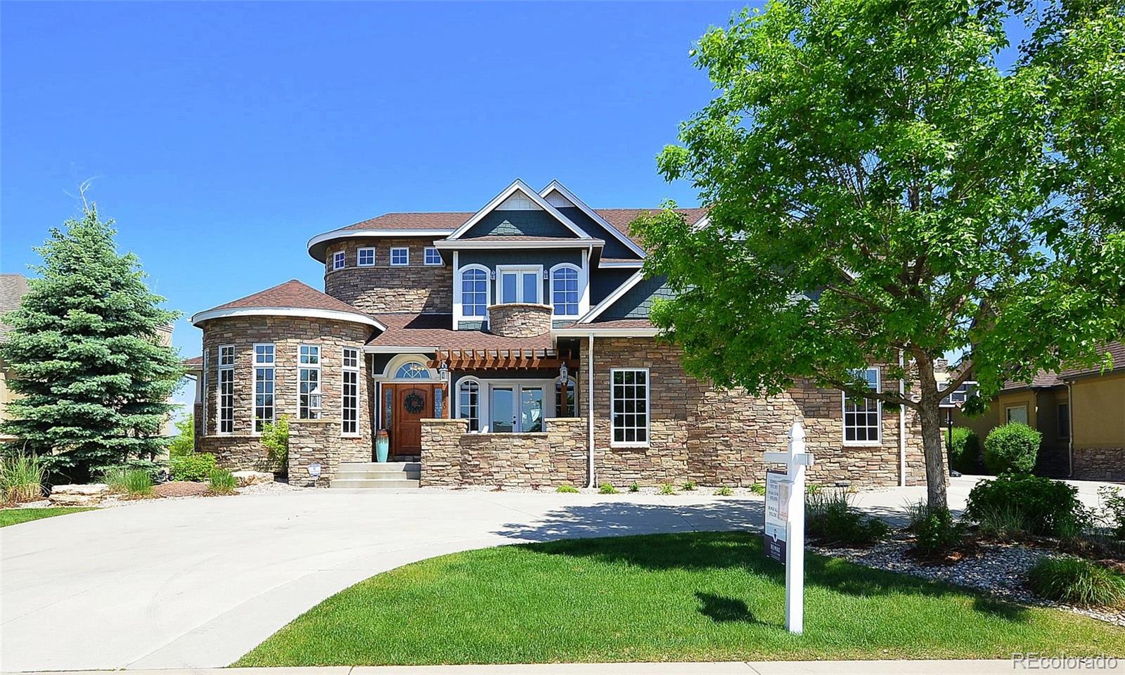 1820 Seashell Court Windsor, CO 80550 - Photo 3 of 40 a front view of a house with a yard