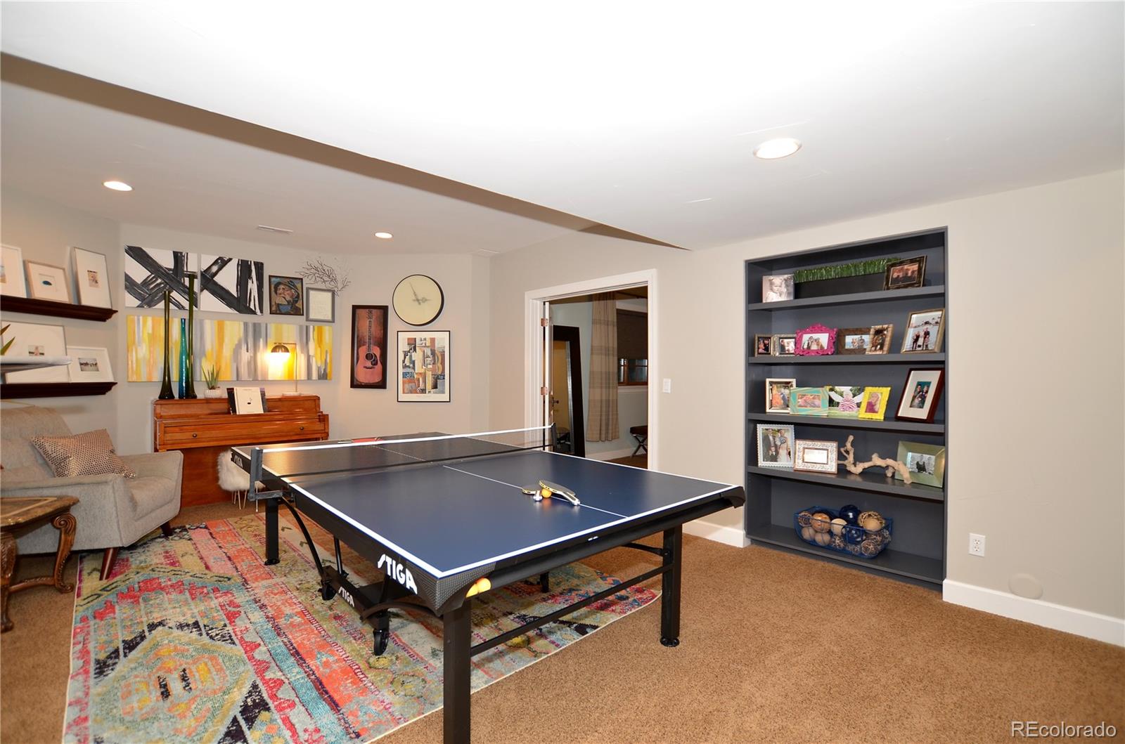 1820 Seashell Court Windsor, CO 80550 - Photo 31 of 40 a living room with furniture a flat screen tv and a table