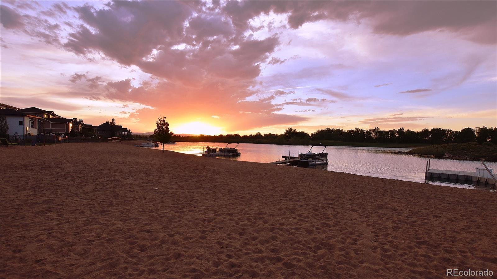 1820 Seashell Court Windsor, CO 80550 - Photo 36 of 40 a view of a lake with houses in the back