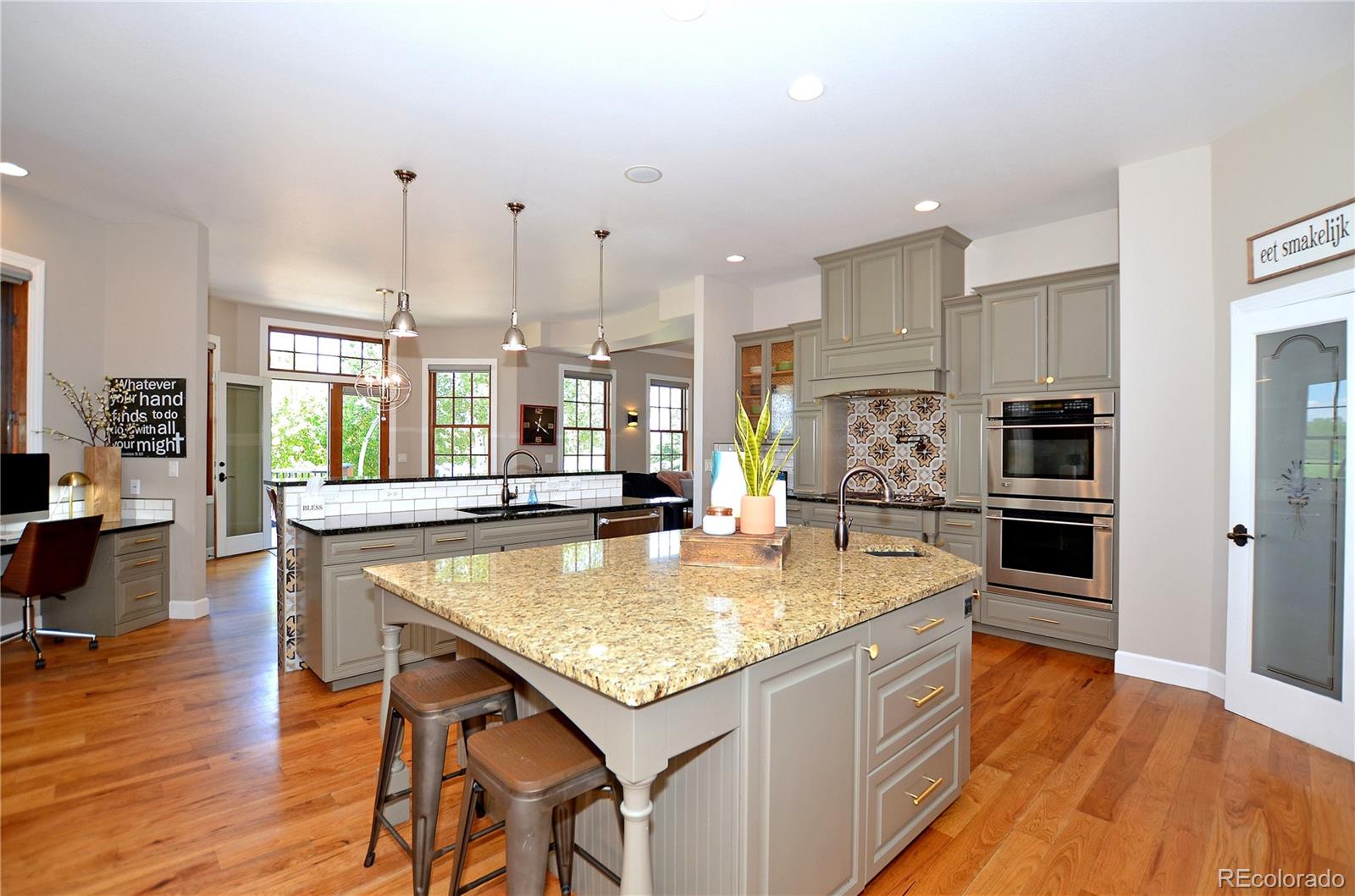 1820 Seashell Court Windsor, CO 80550 - Photo 8 of 40 a large kitchen with kitchen island a counter space a sink appliances and cabinets