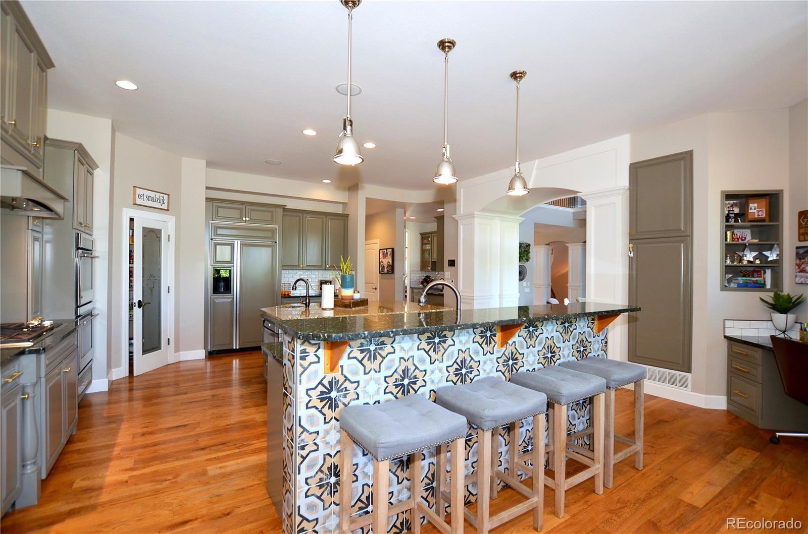 1820 Seashell Court Windsor, CO 80550 - Photo 10 of 40 a view of a dining room and livingroom with furniture wooden floor a chandelier