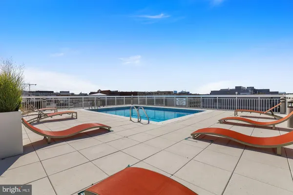a view of a swimming pool with a lounge chair