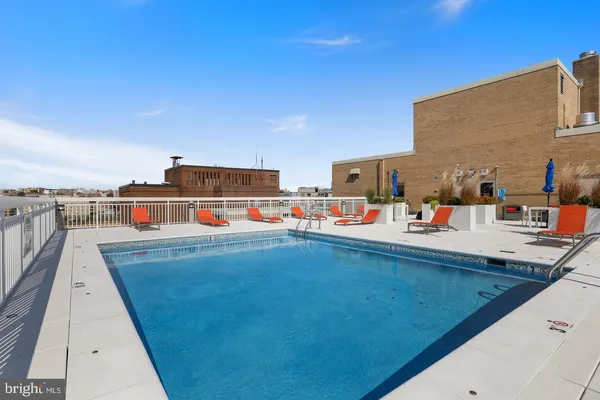 a view of a swimming pool with a lawn chairs