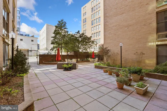 a view of a patio with table and chairs and potted plants