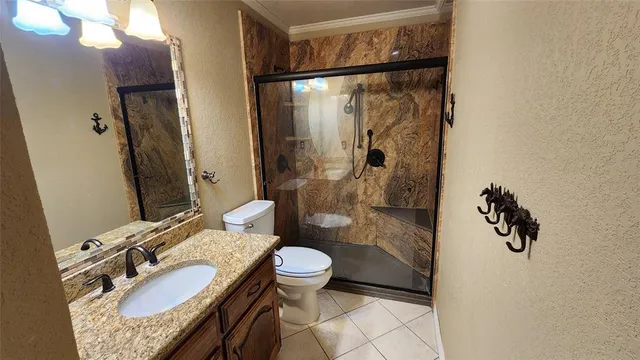 a bathroom with a granite countertop sink toilet and shower