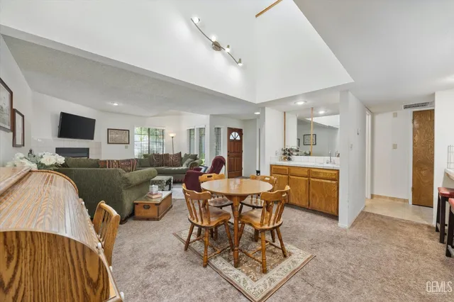 a living room with furniture a dining table and kitchen view