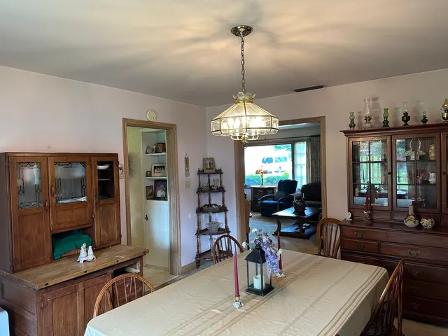 a large kitchen with a table and chairs in it