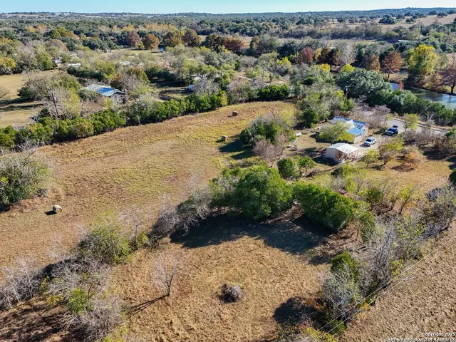 an aerial view of a house with a yard