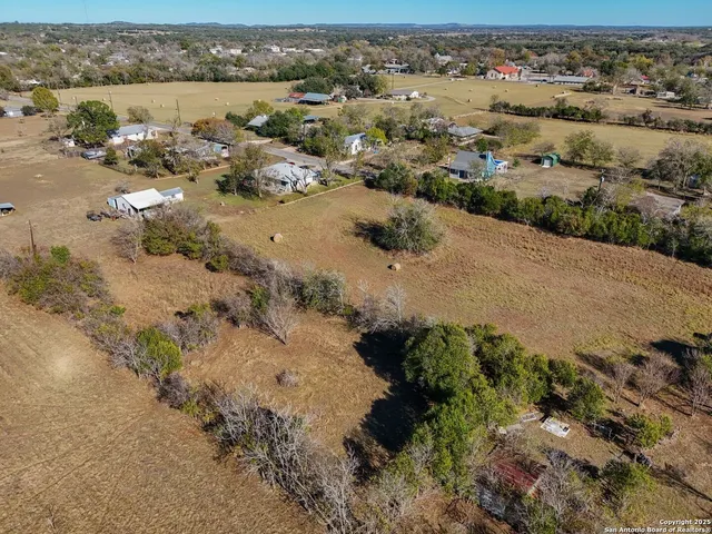 an aerial view of a houses with a lake view