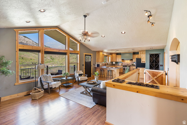 2013 North River View Road Huntsville, UT 84317 - Photo 8 of 53 Living area with a textured ceiling, light wood-style floors, a ceiling fan, recessed lighting, and arched walkways