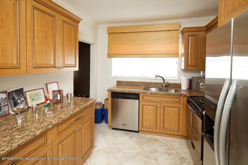 339 Cocoanut Row Palm Beach, FL 33480 - Photo 15 of 25 a kitchen with stainless steel appliances granite countertop a sink stove and refrigerator