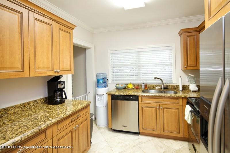 339 Cocoanut Row Palm Beach, FL 33480 - Photo 7 of 25 a kitchen with stainless steel appliances granite countertop a sink stove and refrigerator