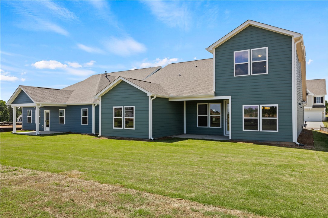 554 Hydrangea Street, Unit LOT 67 Seneca, SC 29678 - Photo 23 of 26 A newly constructed residence showcasing modern design and a generous lawn space, perfect for outdoor activities.