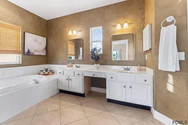 a bathroom with a double vanity sink mirror and toilet