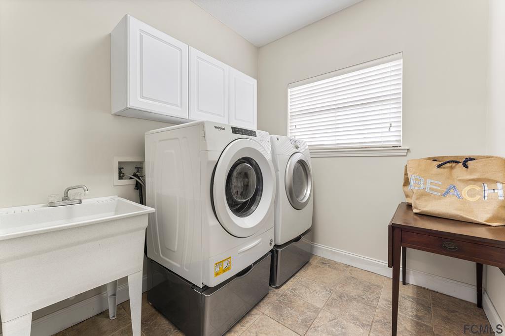 7619 A1A South St. Augustine, FL 32080 - Photo 22 of 51 a utility room with sink dryer and washer