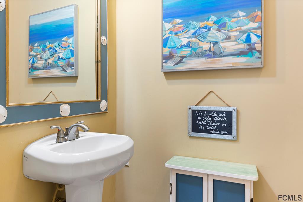 7619 A1A South St. Augustine, FL 32080 - Photo 23 of 51 a bathroom with a sink and a mirror