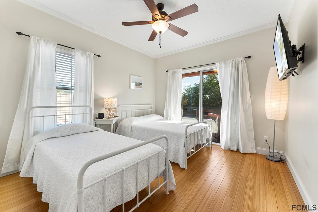 7619 A1A South St. Augustine, FL 32080 - Photo 25 of 51 a bedroom with two beds and a chandelier
