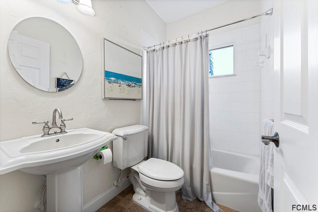 7619 A1A South St. Augustine, FL 32080 - Photo 27 of 51 a bathroom with a sink a toilet and a mirror